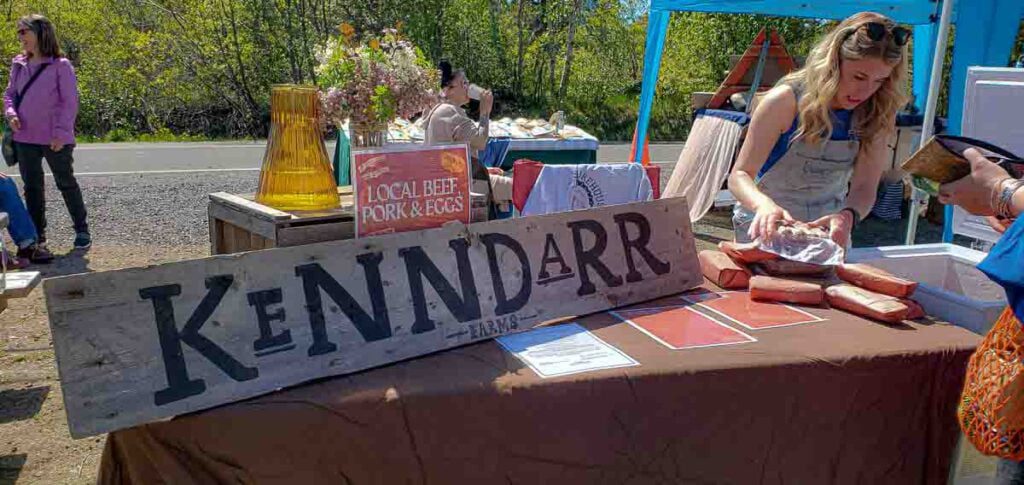 Taylor at the North Mountain Market with a table set up for her meat farm business, Kenndarr Farms. One of many Nova Scotia Businesses