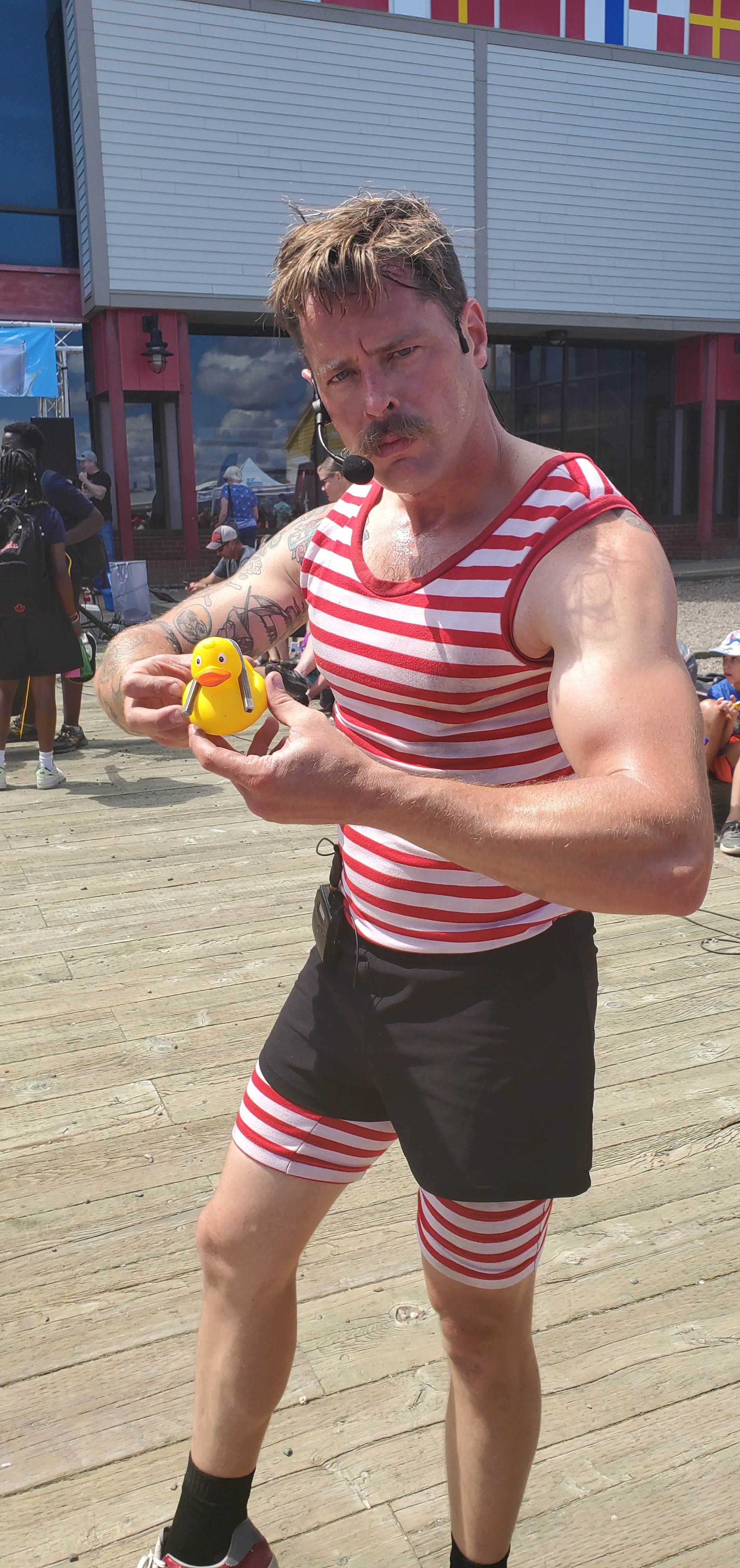 Might Mike, Strongman Performer at the buskers with Mr. Ducky