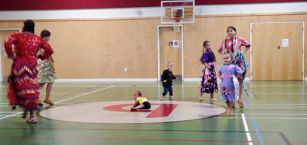 Girls dancing in their jingle dresses